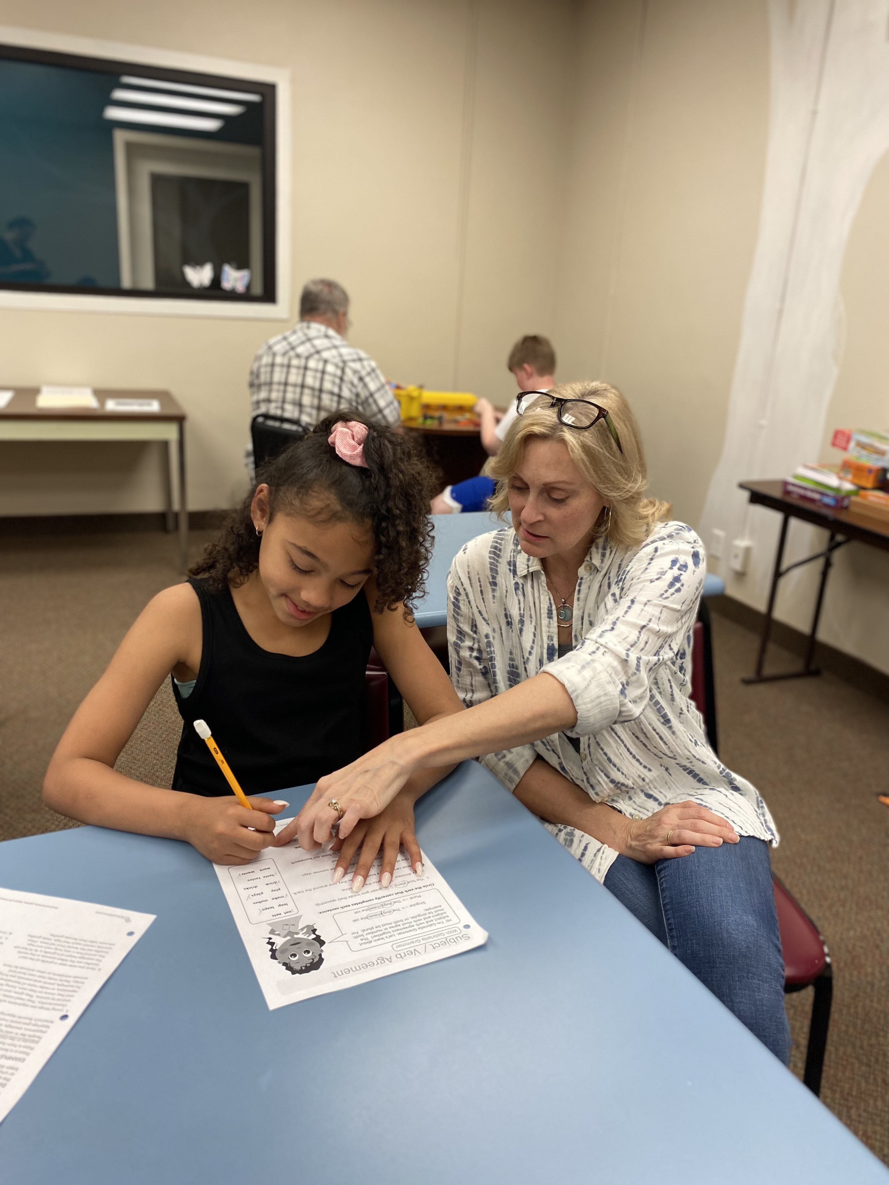 Tutor aids student during On-Track Tutoring at Chautauqua Striders